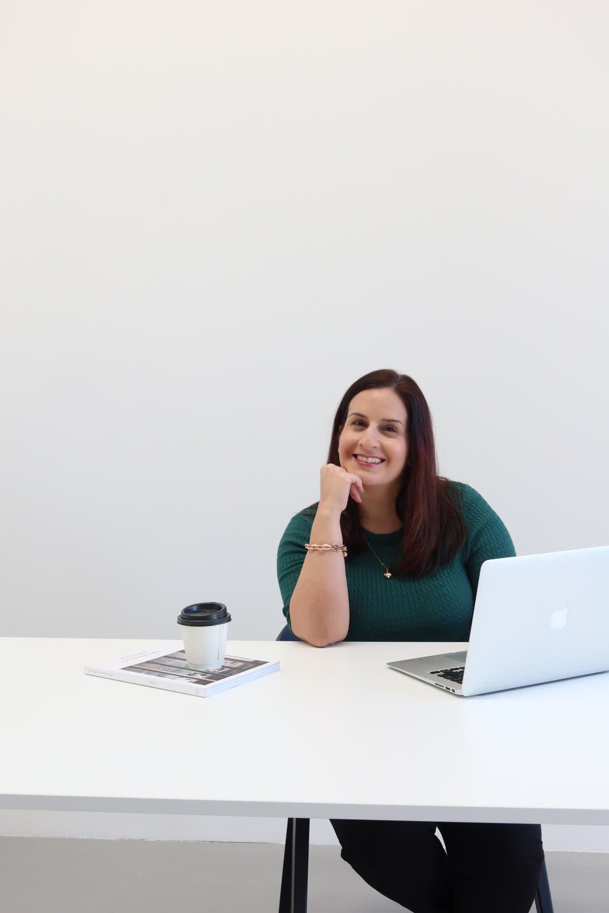 Amelia Ghofrany at her desk during a strategic advisory conversation