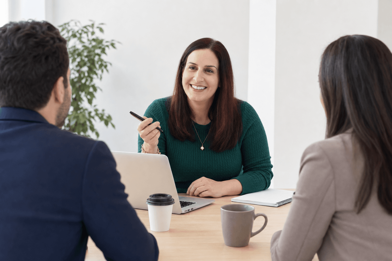 Business partners in conversation around a meeting table